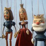 marionettes illustrating a shakespearean quote, "...The seeming truth which cunning times put on To entrap the wisest"